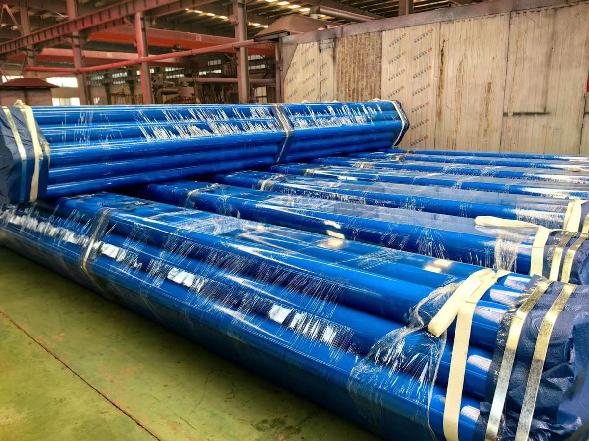 Strapped pipe bundles with protective wrapping
